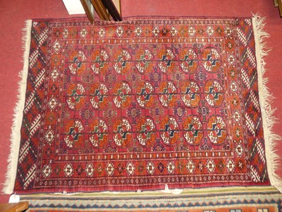 Lot 1132 - A Persian woollen small red ground Bokhara rug,...