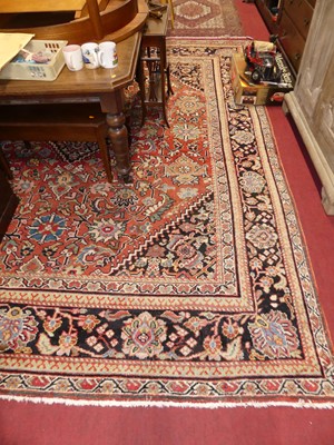 Lot 1140 - A large Persian woollen red ground Tabriz rug,...