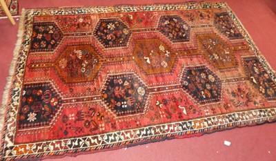 Lot 1142 - A Persian woollen red & blue ground Shiraz rug,...