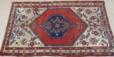 Lot 1323 - A Persian woollen red, blue & cream ground...