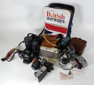 Lot 551 - A collection of cameras and lenses, to include...