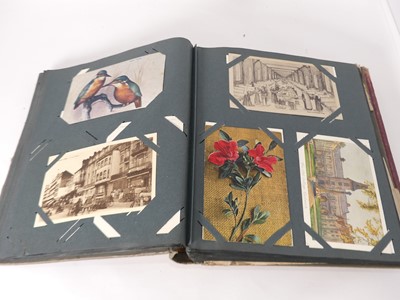 Lot 523 - An early 20th century postcard album and...