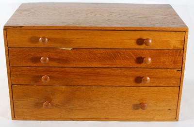 Lot 2101 - A four-drawer collectors' cabinet containing a...