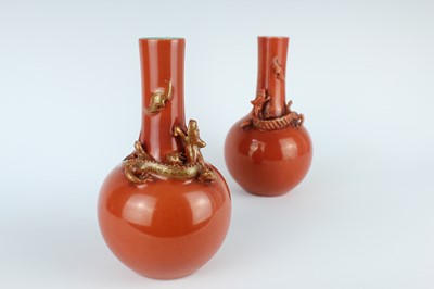 Lot 84 - A pair of Chinese coral-red bottle vases with...