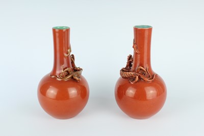 Lot 84 - A pair of Chinese coral-red bottle vases with...