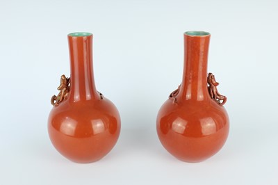 Lot 84 - A pair of Chinese coral-red bottle vases with...