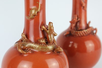 Lot 84 - A pair of Chinese coral-red bottle vases with...