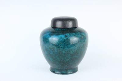 Lot 76 - A Chinese peacock-blue glazed jar with wood...