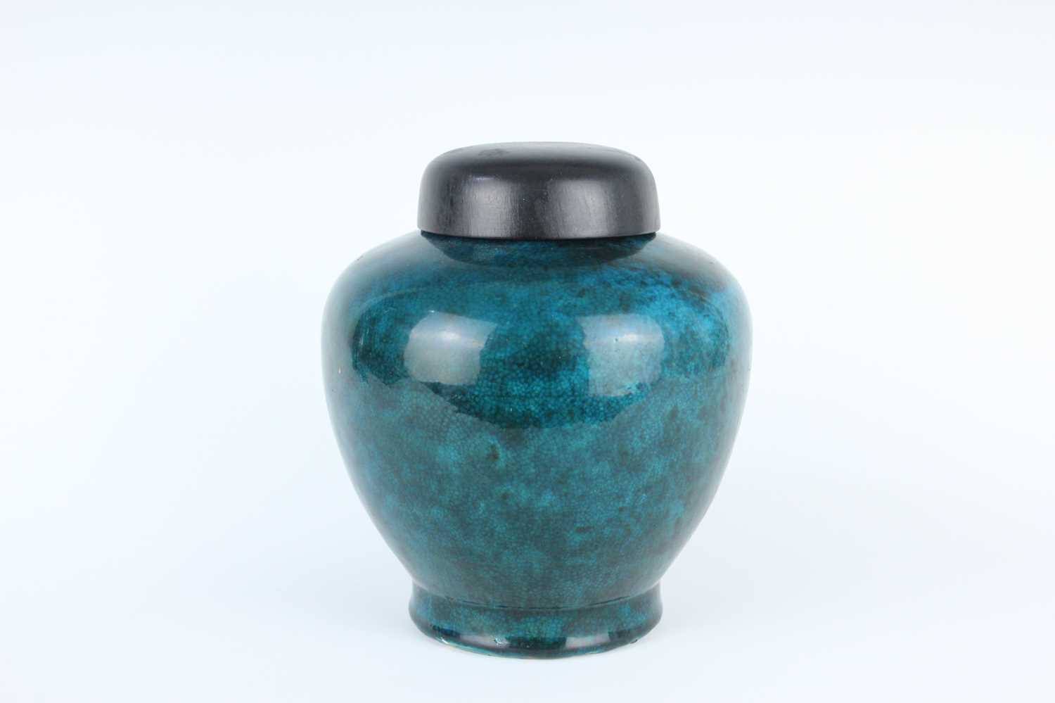 Lot 76 - A Chinese peacock-blue glazed jar with wood...