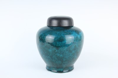 Lot 76 - A Chinese peacock-blue glazed jar with wood...