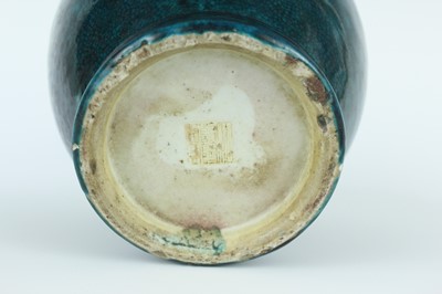 Lot 76 - A Chinese peacock-blue glazed jar with wood...