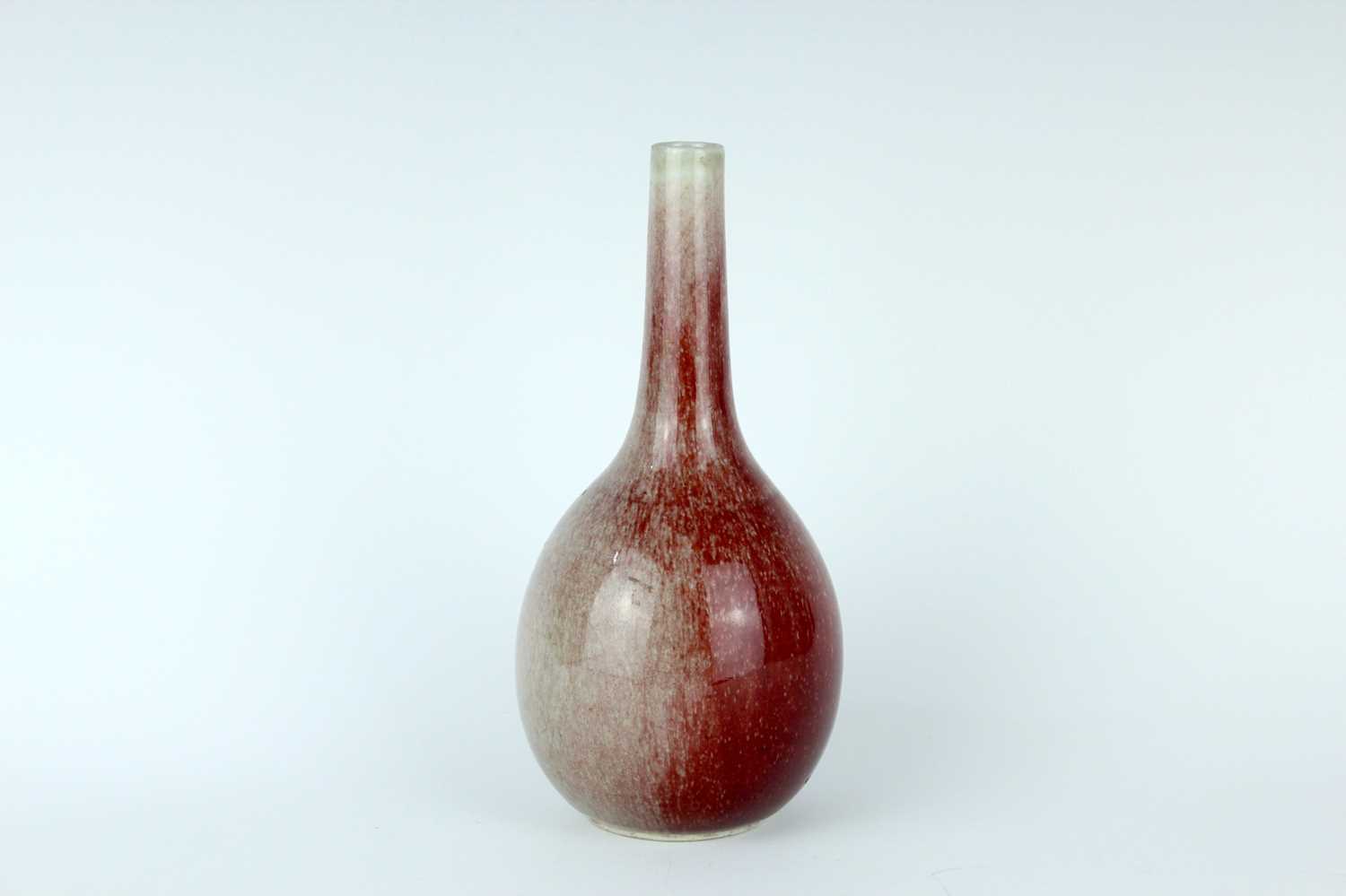 Lot 86 - A Chinese peach-bloom-glazed bottle vase, Qing...