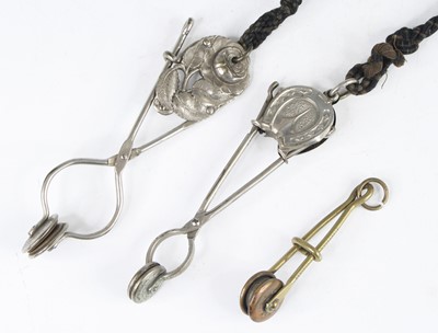 Lot 355 - A Victorian white metal skirt lifter of...
