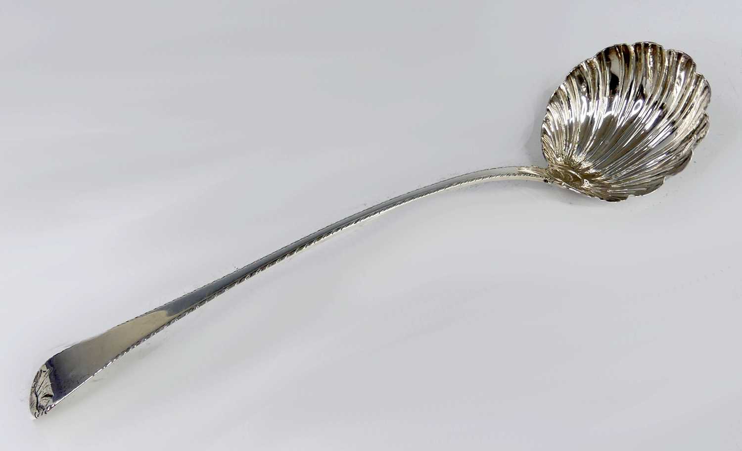 Lot 2099 - A George III silver soup ladle, in the Feather-...
