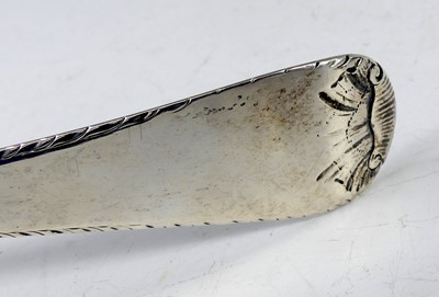 Lot 2099 - A George III silver soup ladle, in the Feather-...