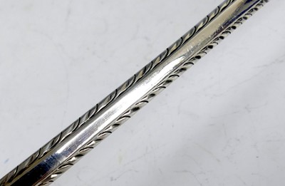 Lot 2099 - A George III silver soup ladle, in the Feather-...