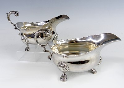 Lot 2183 - A pair of George VI silver sauceboats, having...