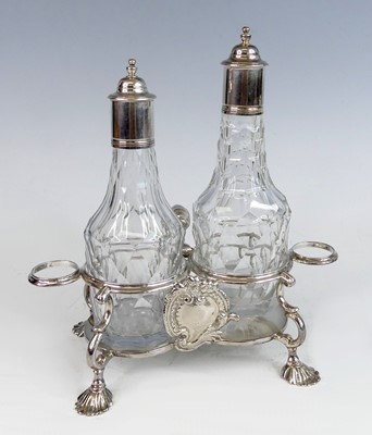 Lot 2195 - A George II silver twin bottle cruet stand,...