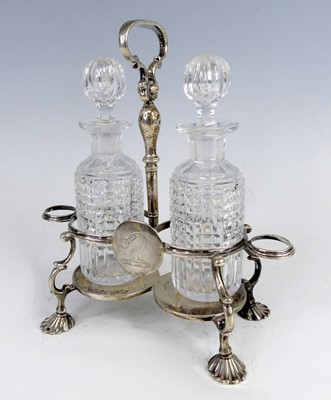 Lot 2194 - A George II silver two bottle cruet stand,...