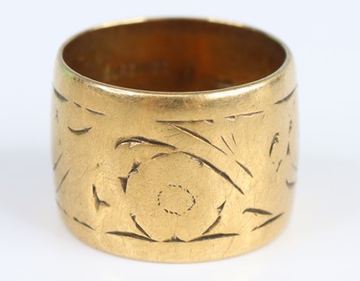 Lot 2707 - A 9ct yellow gold 14mm engraved wedding band,...
