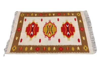 Lot 1133 - A Kilim style rug with cream ground with...