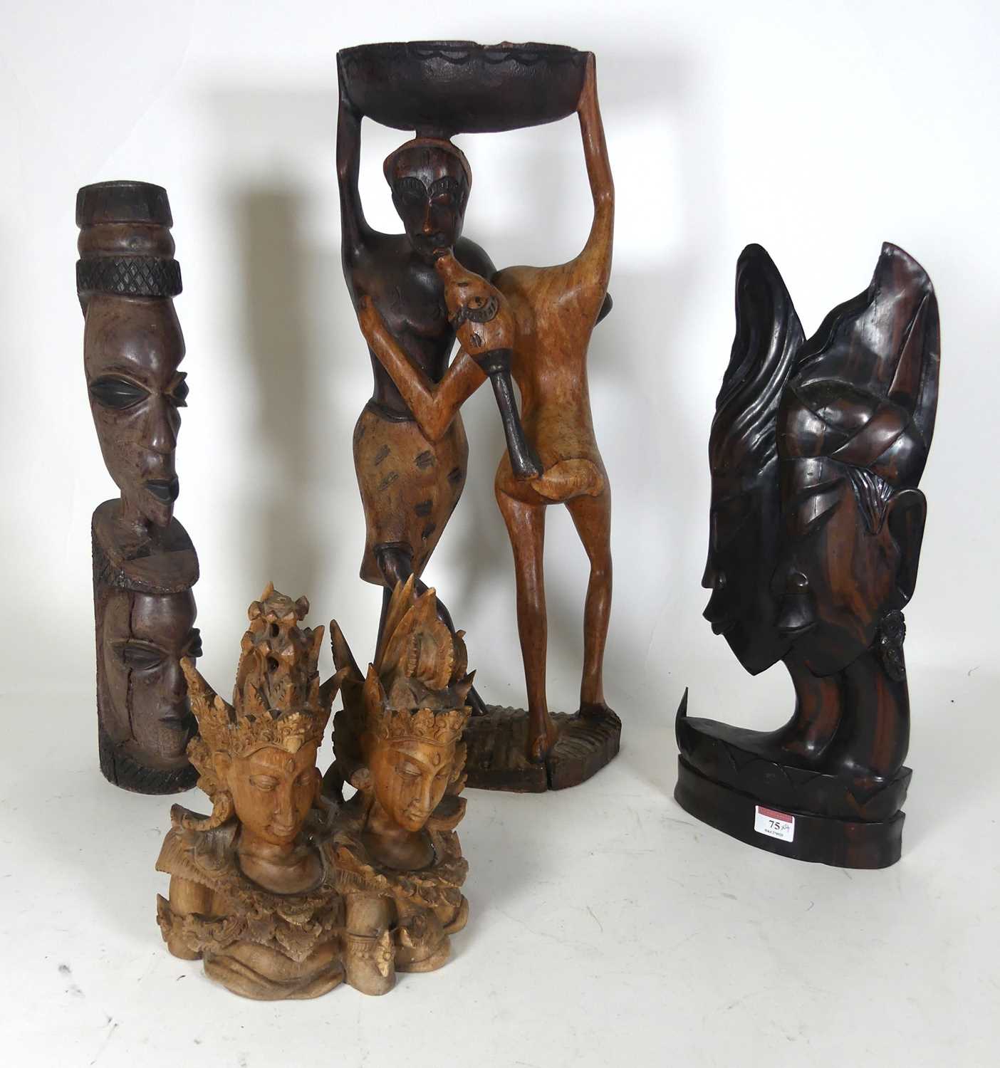 Lot 75 - A collection of wooden African tribal art, the...