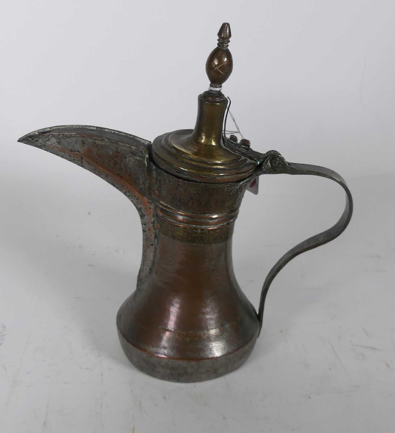 Lot 105 - A Middle-Eastern brass dallah