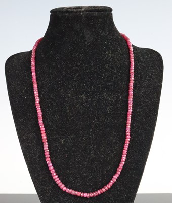 Lot 324 - A ruby bead necklace, the slightly graduated...