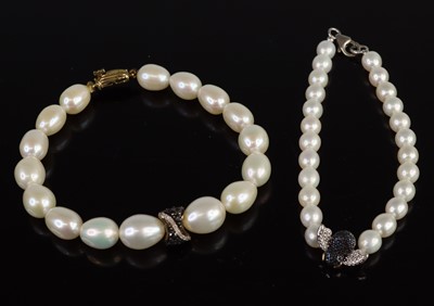 Lot 321 - Two cultured pearl and diamond bracelets: to...