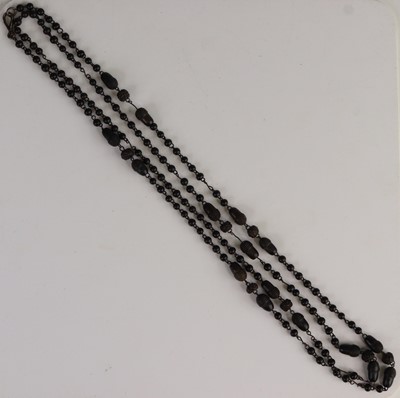 Lot 325 - A bog oak necklace, comprised of round, carved...