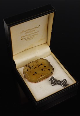 Lot 320 - A moss agate specimen brooch in unmarked...