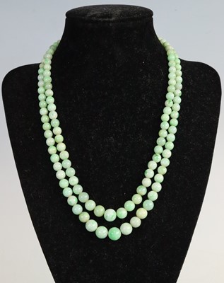 Lot 329 - A beaded nephrite two-string choker, the beads...