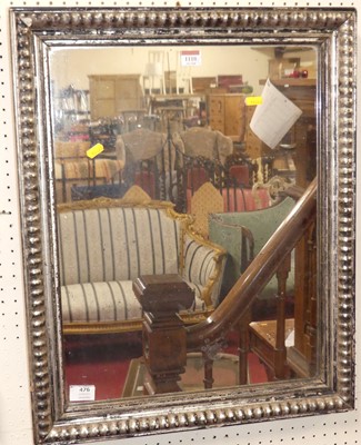Lot 1110 - A silvered wood framed rectangular wall mirror,...