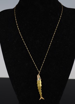 Lot 314 - A yellow metal reticulated fish pendant,...