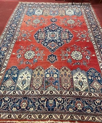 Lot 1124 - A large Persian red, blue and cream ground...