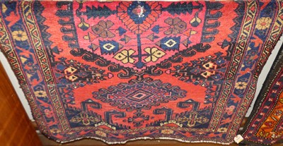 Lot 1128 - A Persian woollen red and blue ground Baluch...