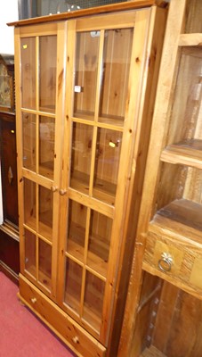 Lot 1148 - A contemporary pine double door glazed...