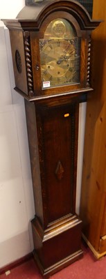 Lot 1149 - A 1930s oak grandmother clock, the arched...