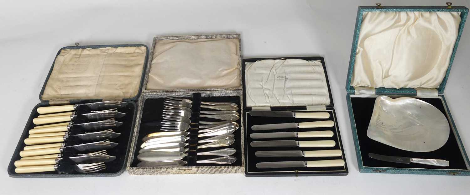 Lot 202 - Four boxed cutlery sets, to include silver...