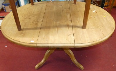 Lot 1171 - A contemporary pine pedestal extending dining...