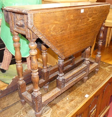 Lot 1210 - A floral line carved oak gateleg occasional table