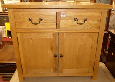 Lot 1229 - A contemporary small blond oak double door...