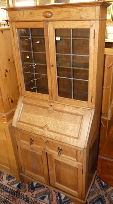 Lot 1247 - An early 20th century oak bureau bookcase,...