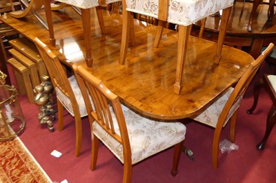 Lot 1255 - A contemporary yew dining suite, comprising;...