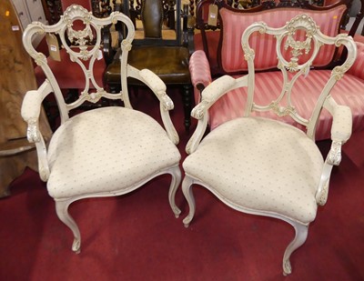 Lot 1294 - A pair of French pale painted tub elbow chairs,...