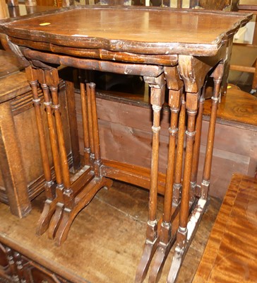 Lot 1303 - A walnut nest of three occasional tables,...
