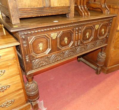 Lot 1305 - A joined and relief carved oak two drawer...