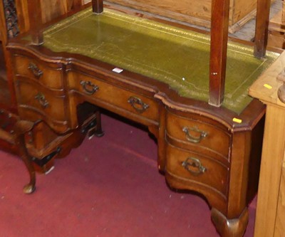Lot 1320 - A walnut and green leather inset kneehole...