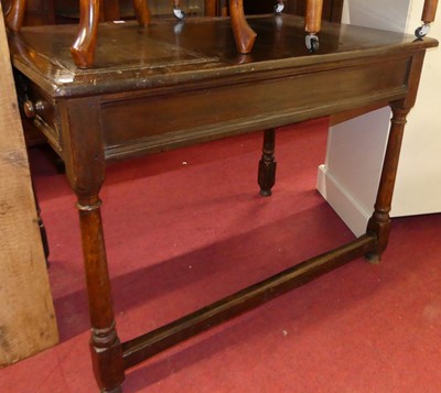 Lot 1334 - A Waring & Gillow joined oak and tan leather...