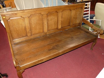 Lot 1345 - A joined oak five-panel settle, having a...